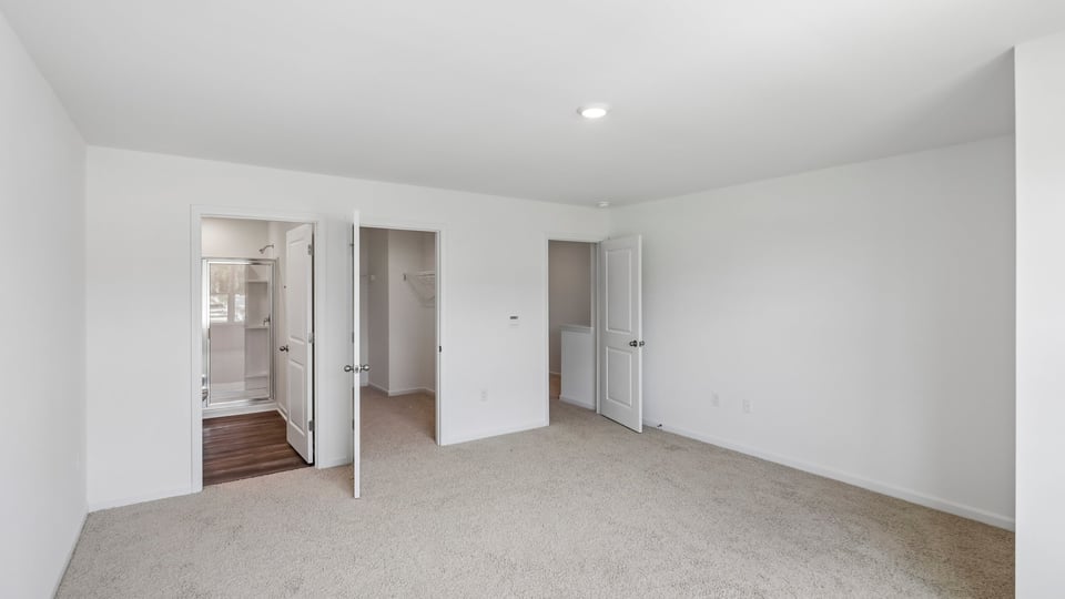 primary bedroom with carpet flooring