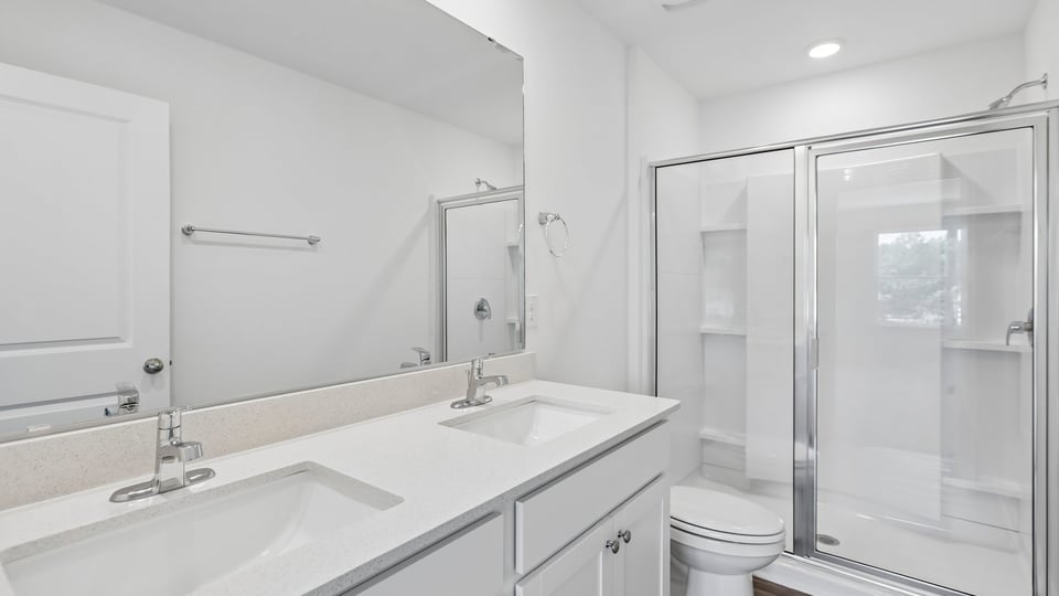 bathroom with walkin glass door shower and white cabinets