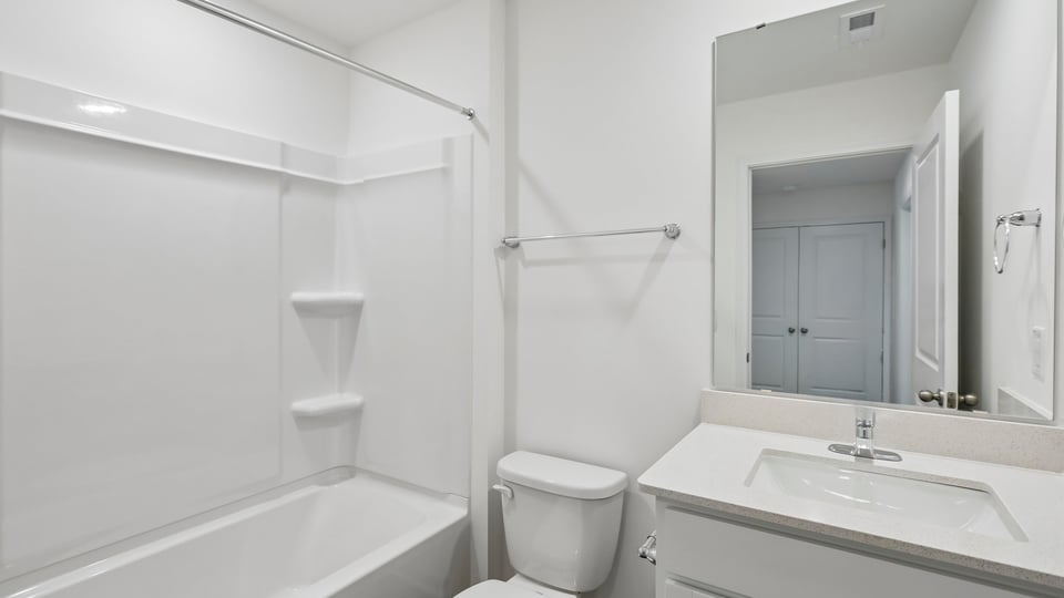 bathroom with tub shower combo and quartz countertops