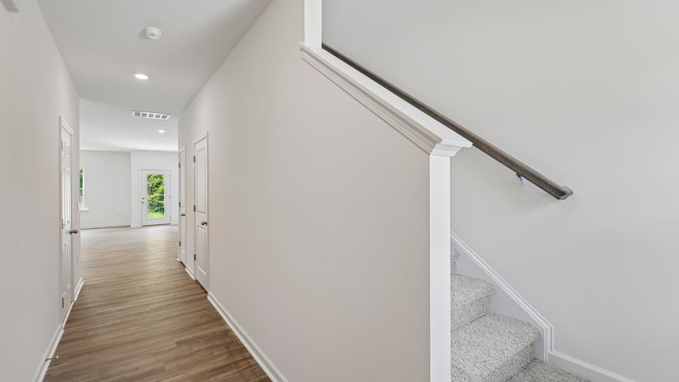 foyer entryway with carpeted staircase
