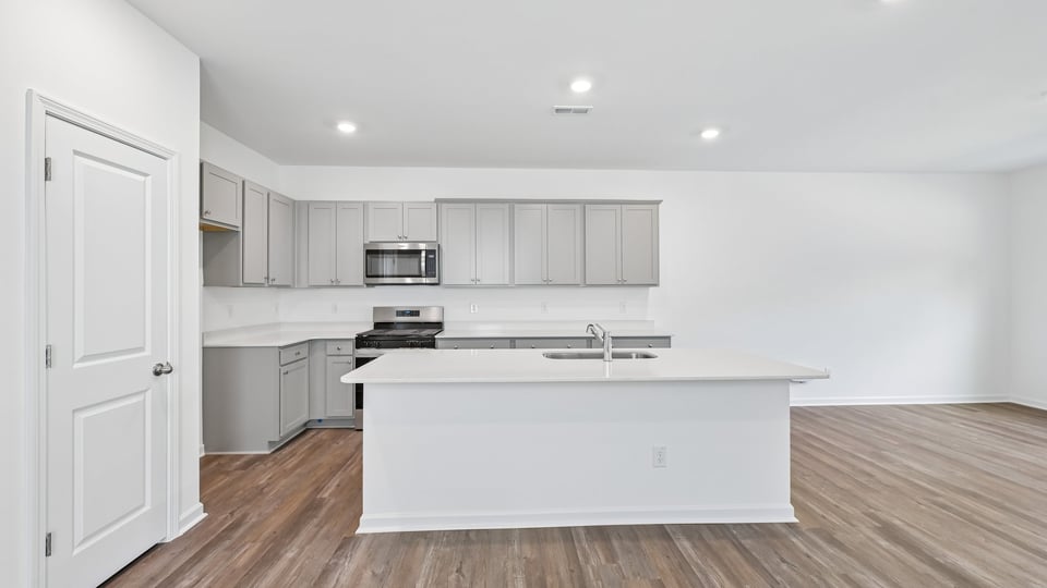 kitchen with gray cabinets quartz countertops and spacious island
