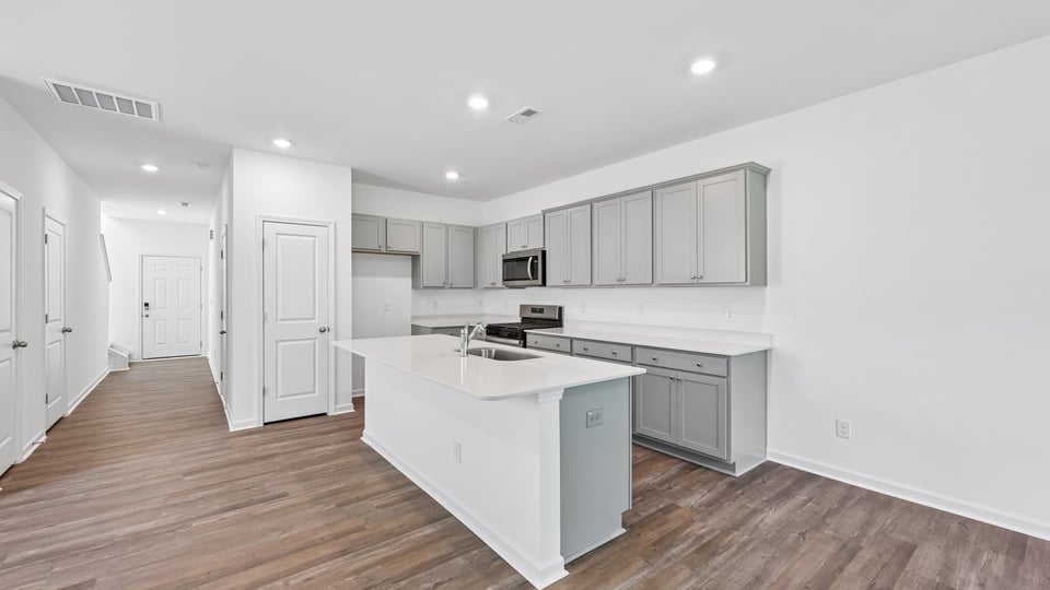 kitchen with gray cabinets quartz countertops and spacious island