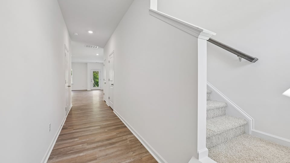 foyer entryway with carpeted staircase