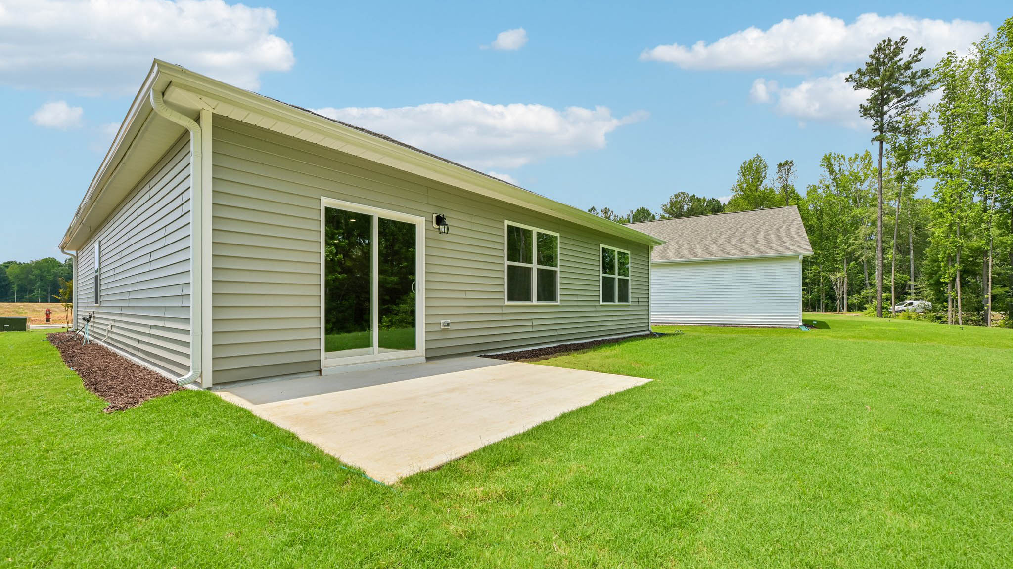 exterior patio with concrete slab and open yard
