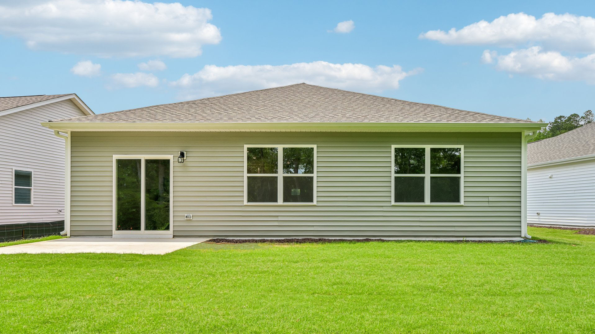 back exterior of freeport with patio and open yard
