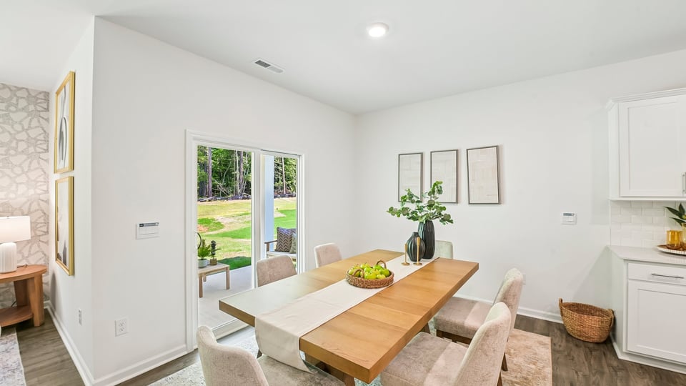 open concept dining space with door to patio