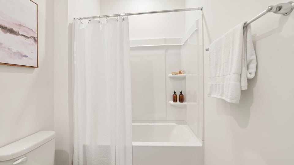 secondary bathroom with shower tub combo and single vanity sink