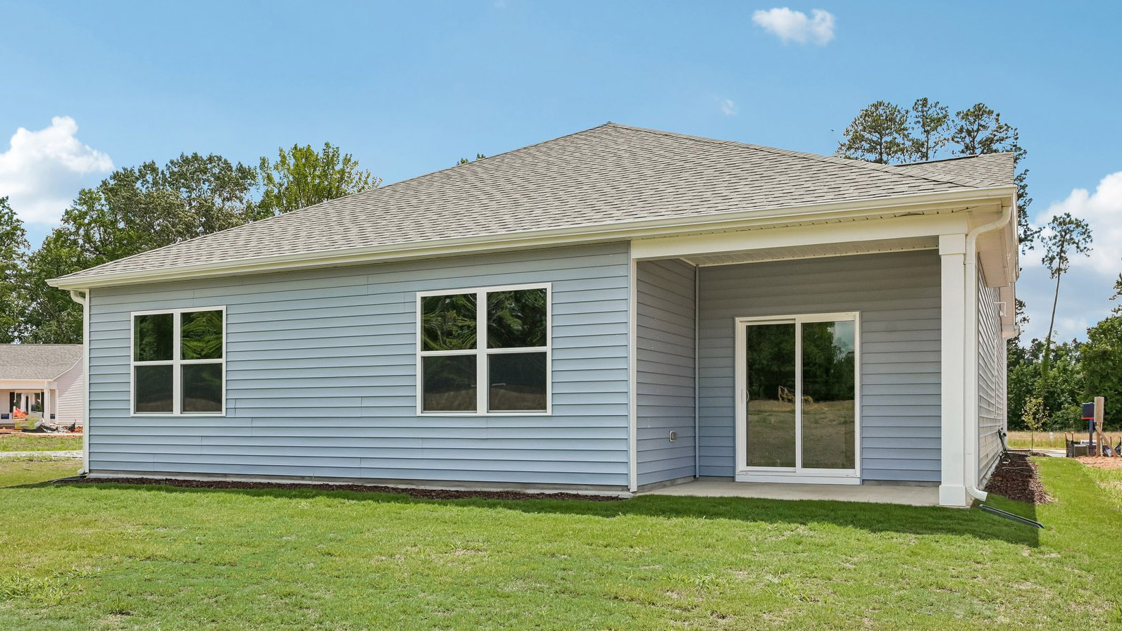 back exterior cali Q with covered patio and open yard