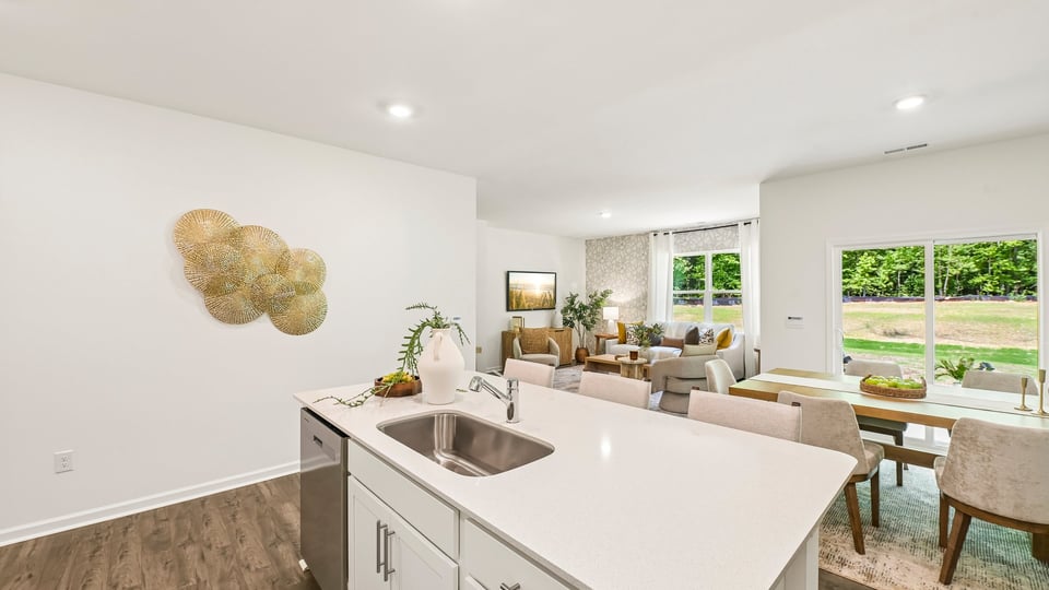 kitchen with quartz counters, kitchen island, pantry, stainless steel appliances