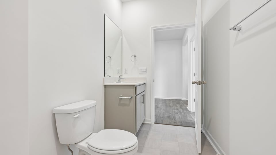 secondary bathroom with gray cabinets and quartz countertops