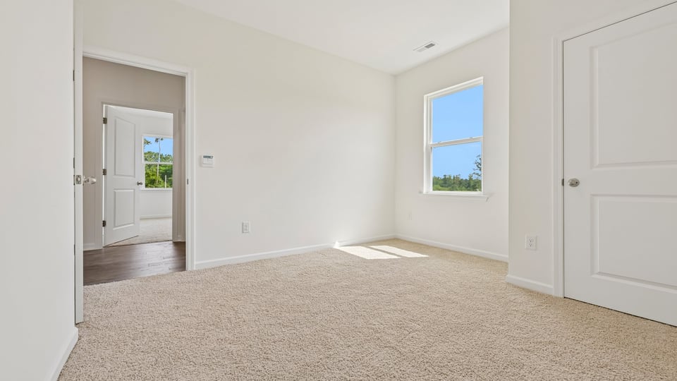 primary bedroom with carpet flooring