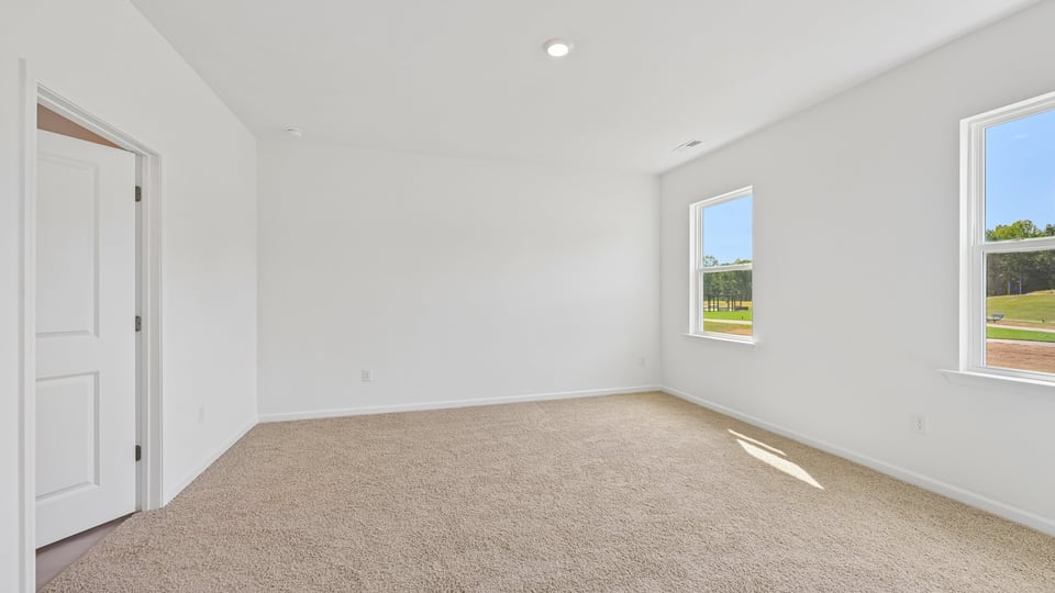 primary bedroom with carpet flooring