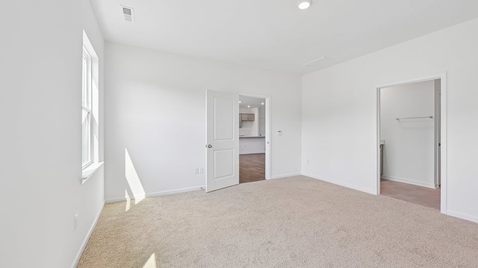 primary bedroom with carpet flooring