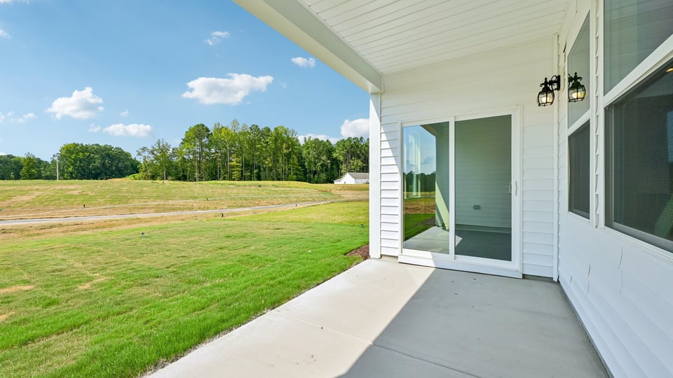 covered concrete patio with sliding glass doors