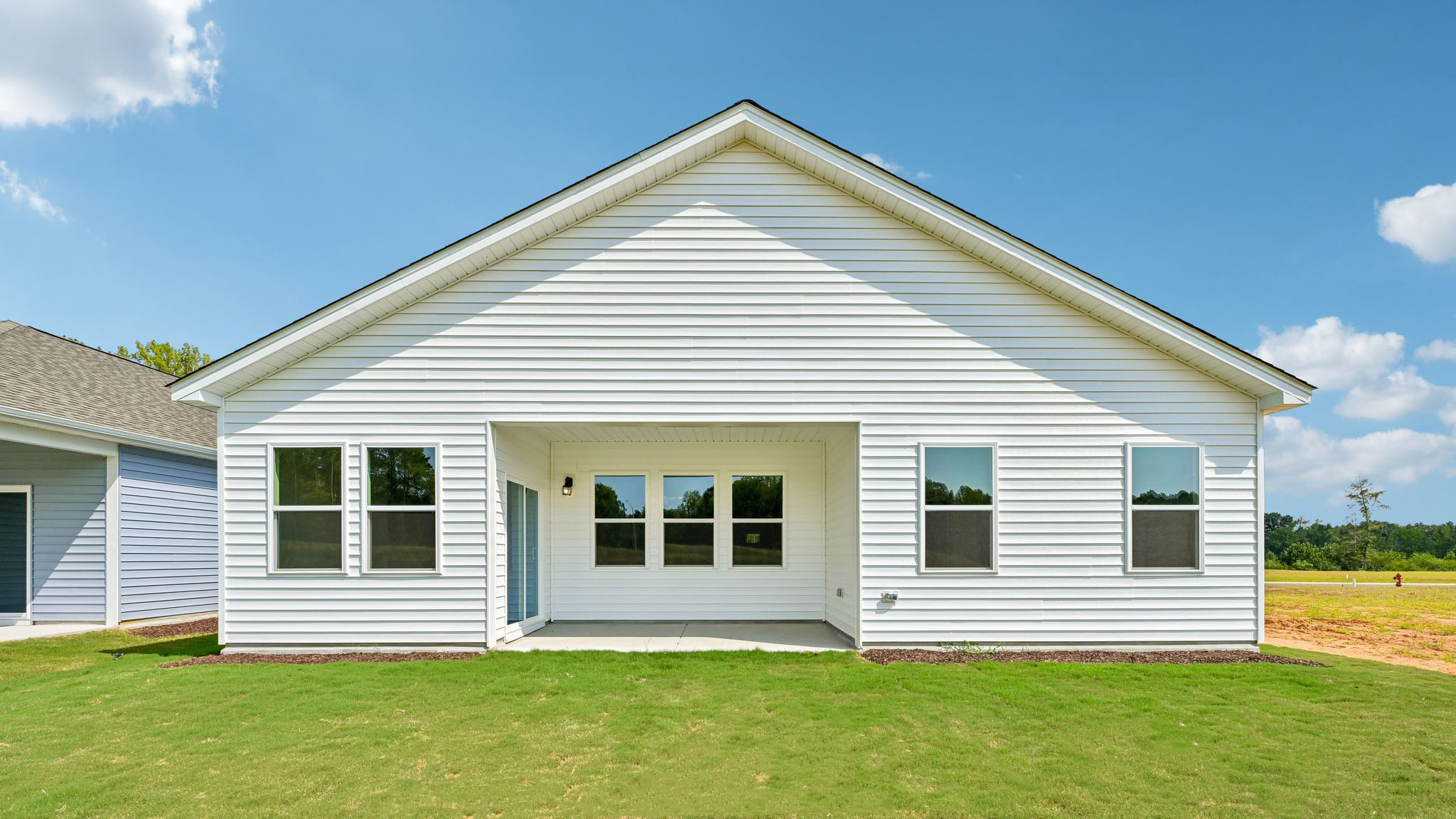 back of home with covered concrete patio