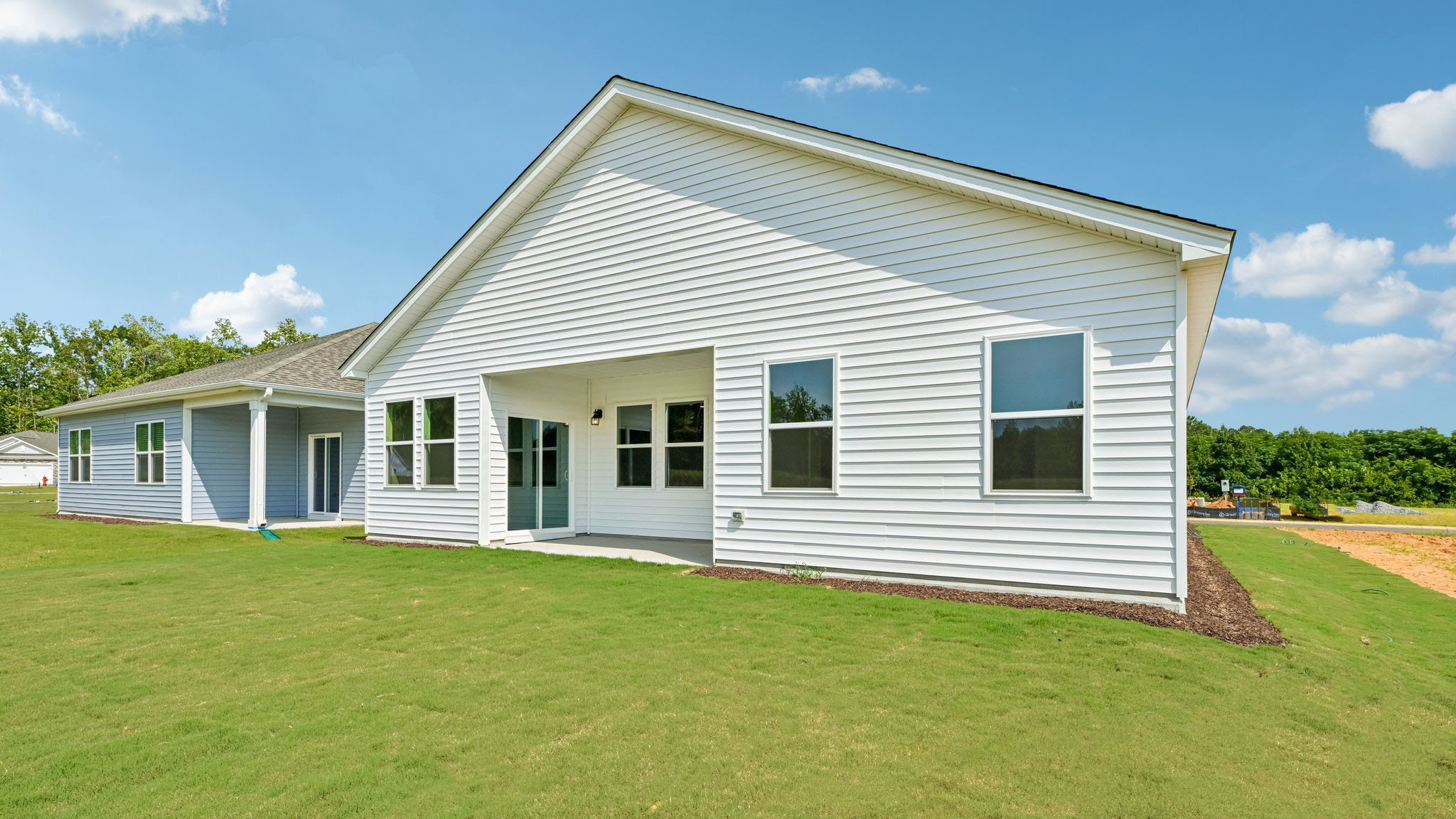 back of home with covered concrete patio