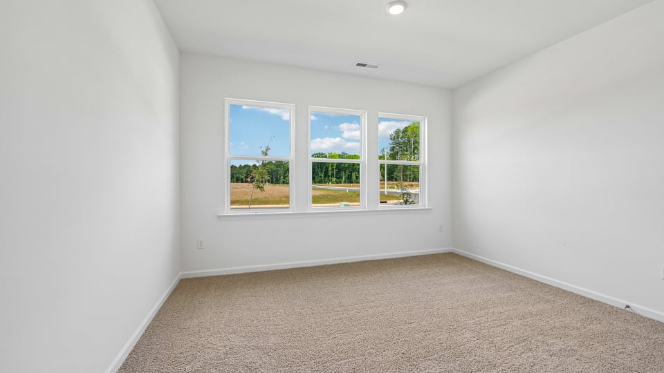 additional bedroom with window, carpeting, closet