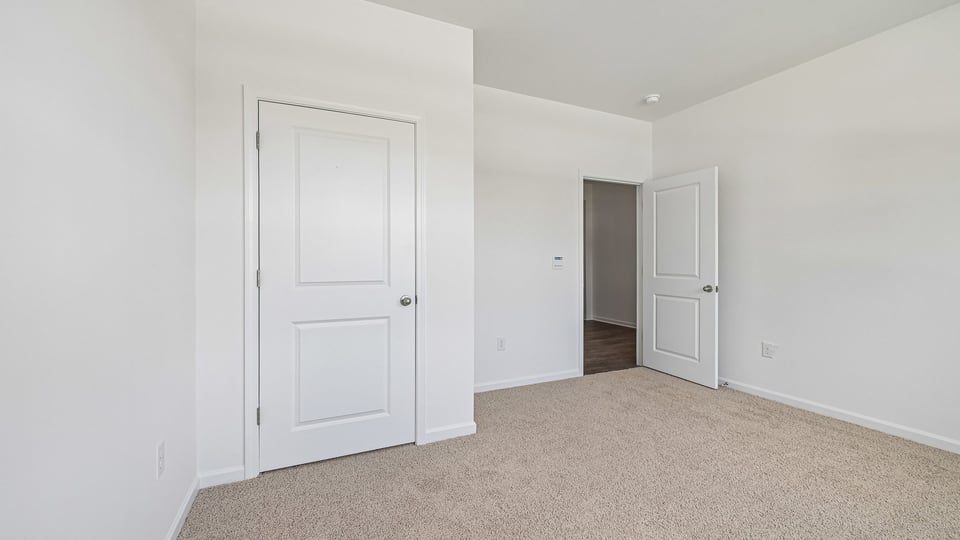 additional bedroom with window, carpeting, closet
