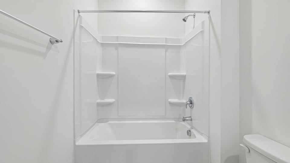 secondary bathroom with shower tub combo and single vanity sink
