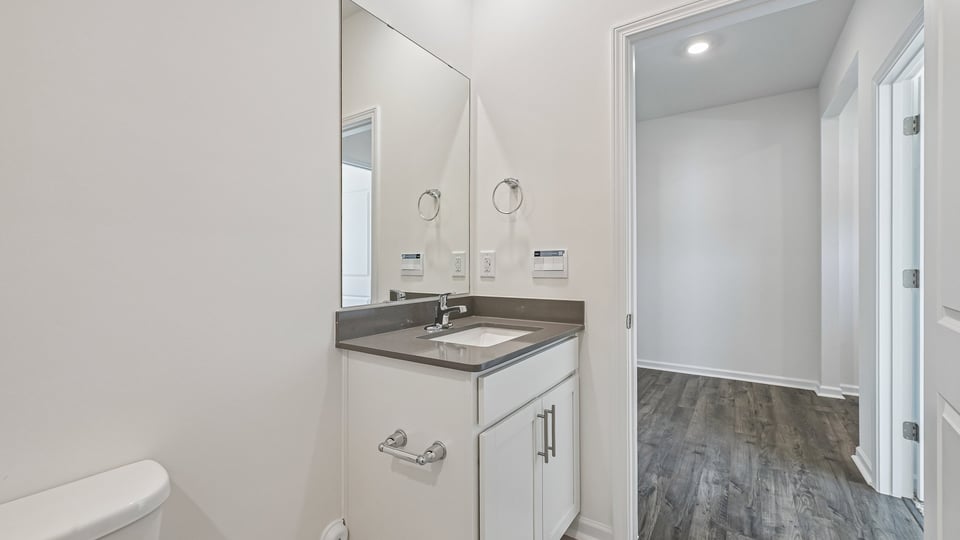 secondary bathroom with shower tub combo and single vanity sink