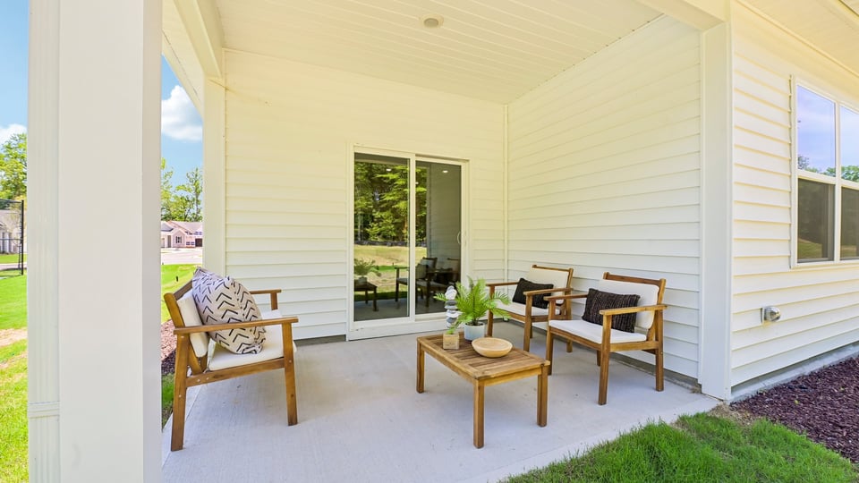 covered exterior patio with concrete slab and open yard