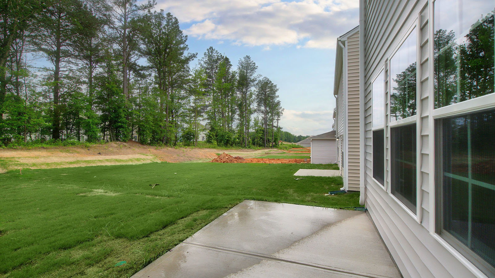 exterior patio with concrete slab and open yard