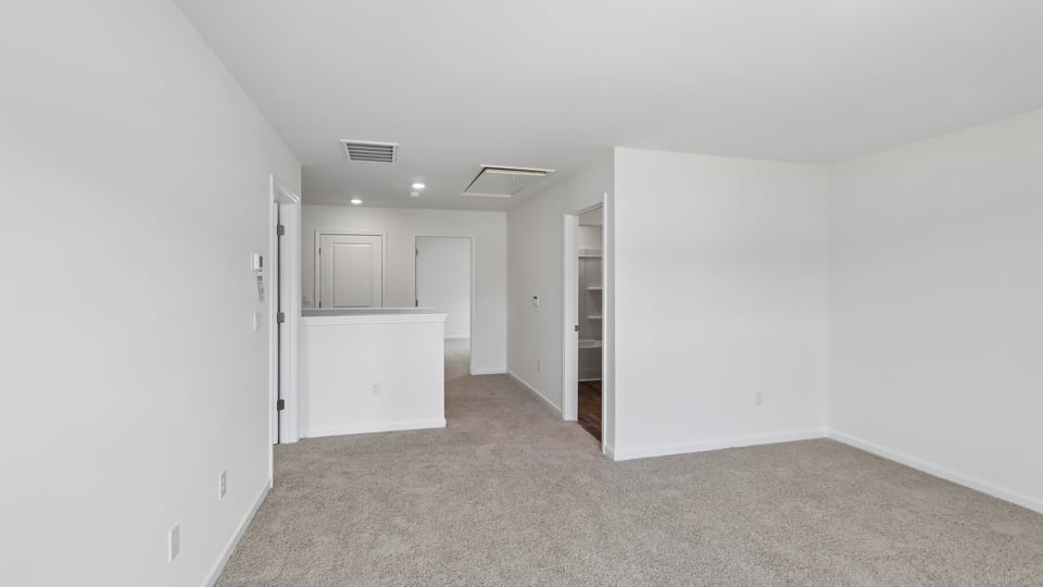 upstairs loft area with large windows and carpeting
