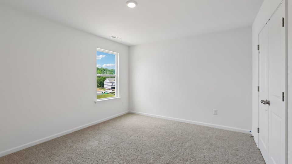 additional bedroom with window, carpeting, closet