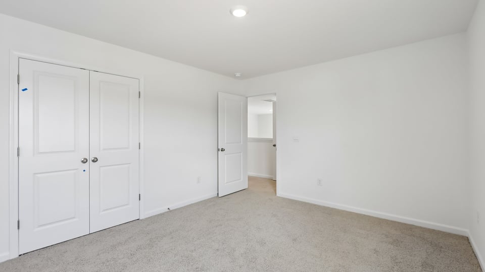 additional bedroom with window, carpeting, closet