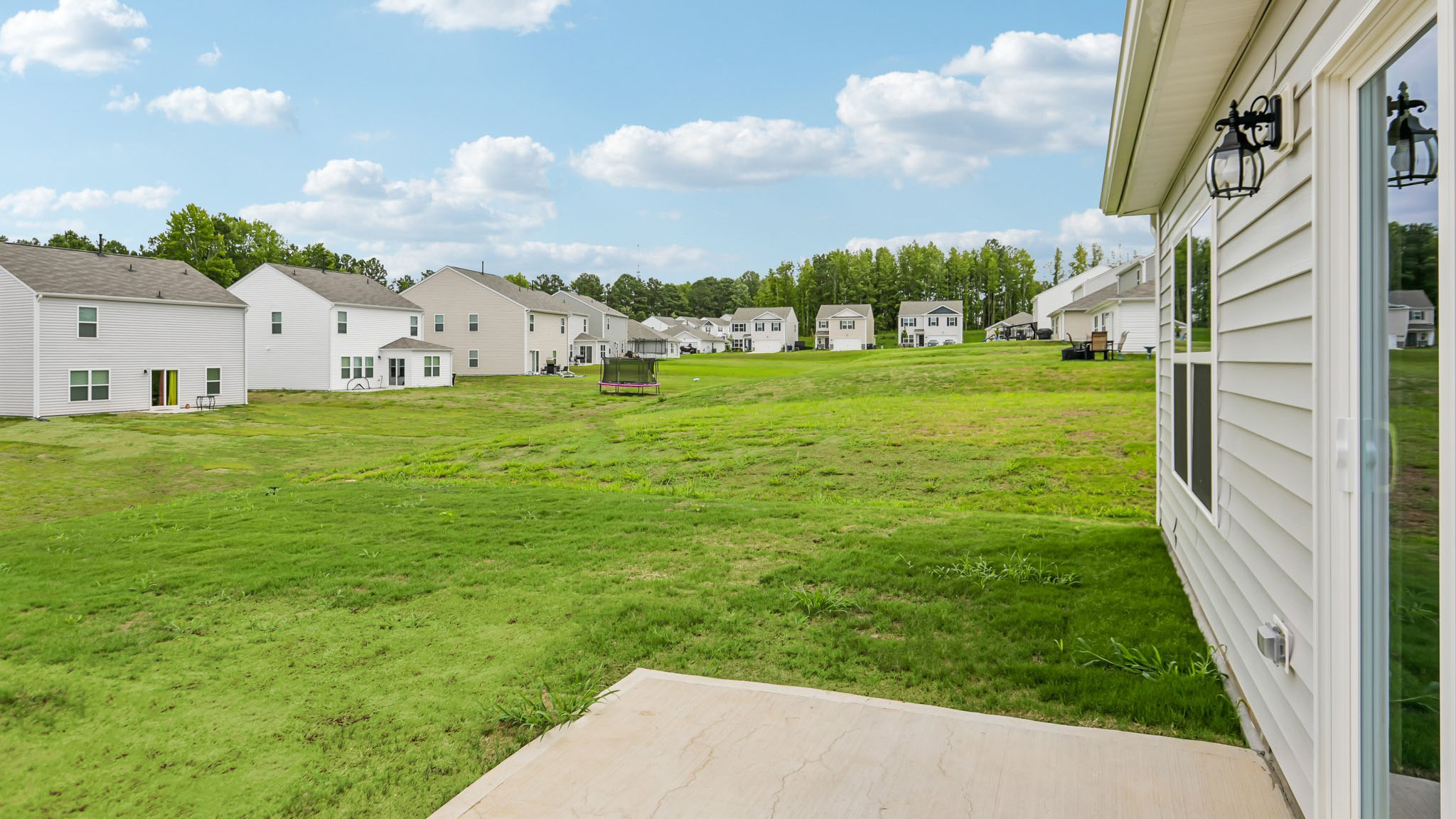 exterior patio with concrete slab and open yard