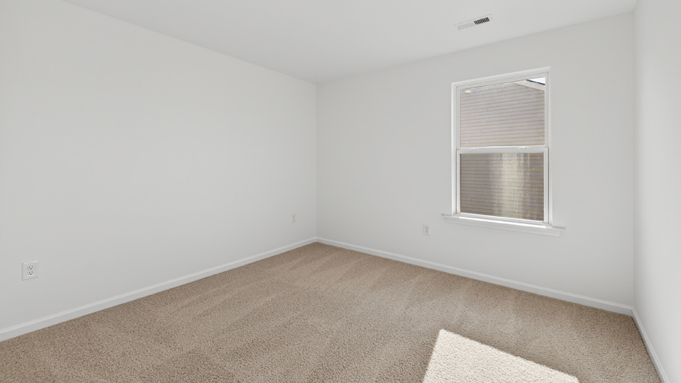 additional bedroom with window, carpeting, closet