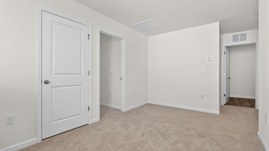 upstairs loft area with large windows and carpeting