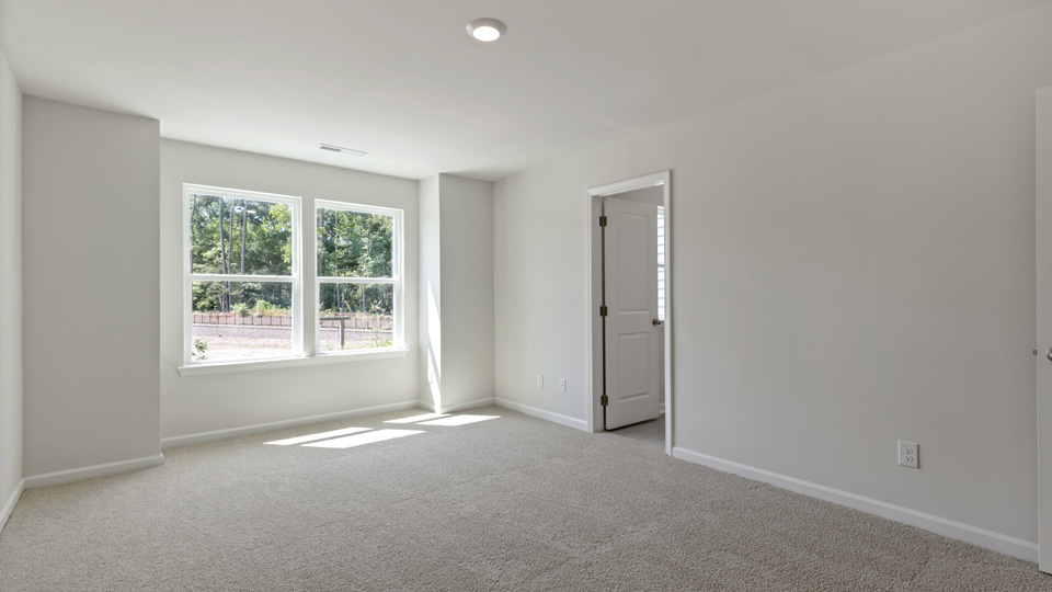 Primary bedroom with carpet flooring