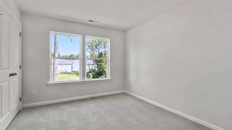 Bedroom with carpet flooring and windors