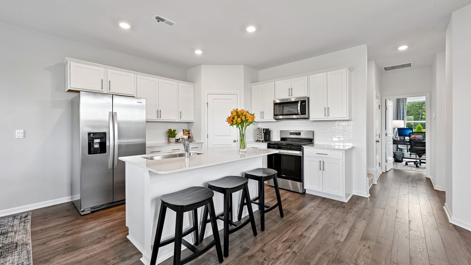 kitchen with island white cabinets and quartz countertops