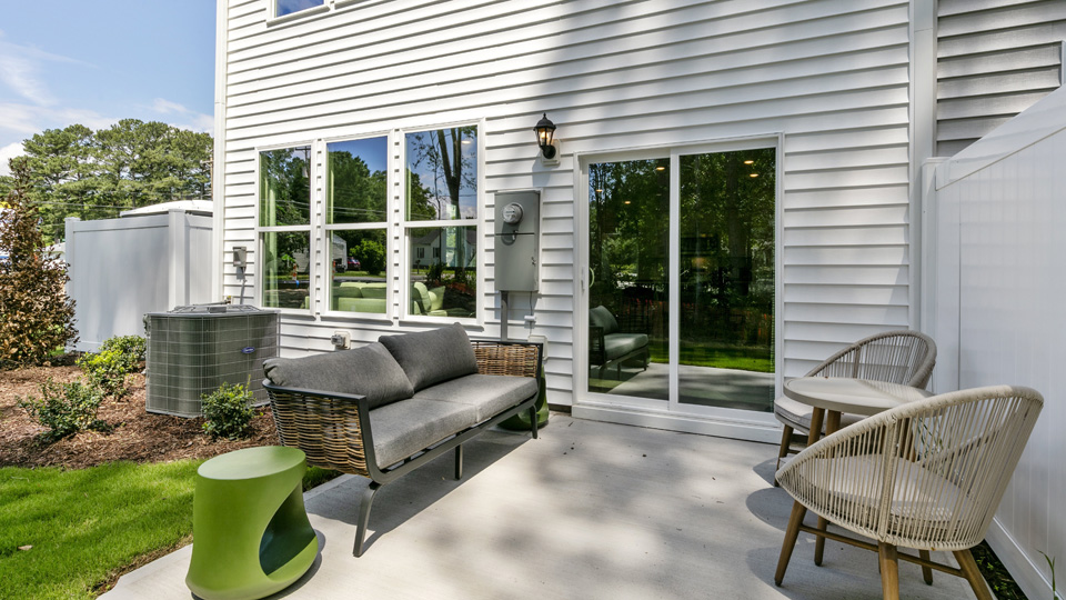 patio space with small backyard, grass