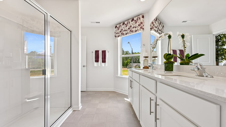 paimary bathroom with walkin shower and quartz countertops