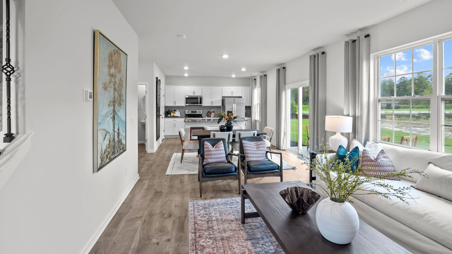 open concept living areas overlooked by kitchen