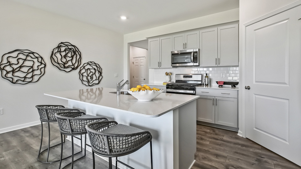 kitchen with white cabinets quartz countertops and stainless steel appliances