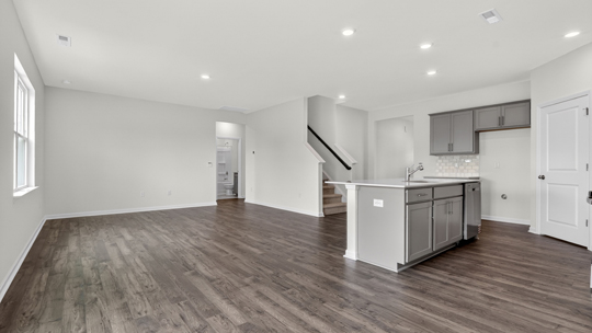 open concept living area overlooked by kitchen