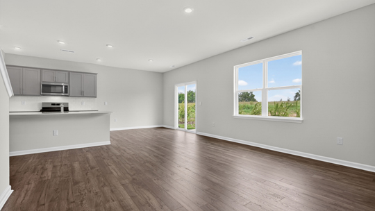 open concept living area overlooked by kitchen