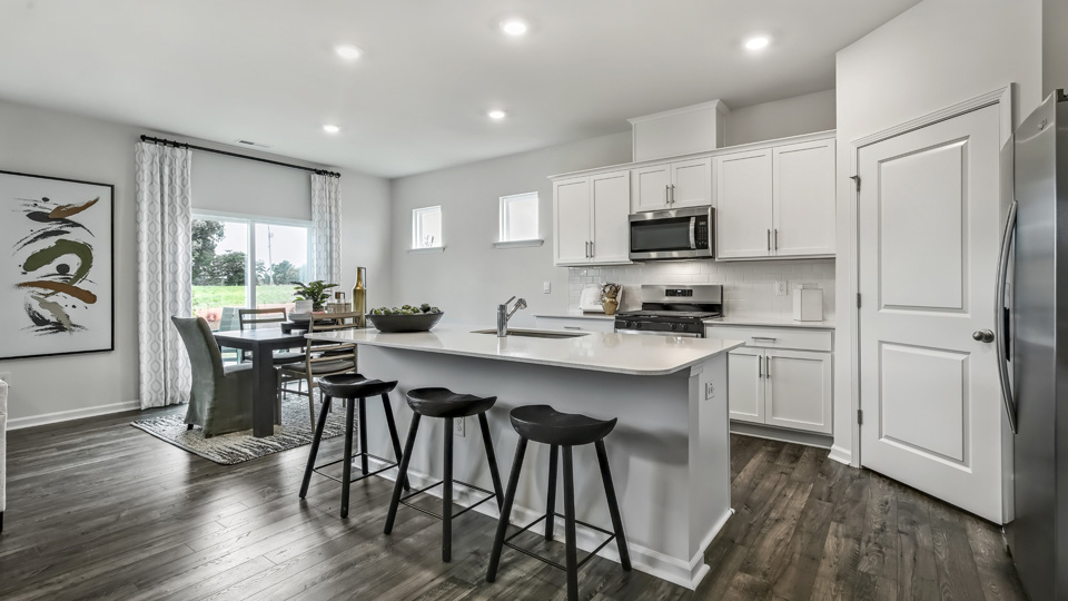 kitchen with island white cabinets and quartz countertops