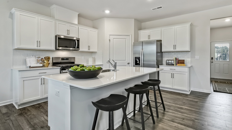 kitchen with island white cabinets and quartz countertops