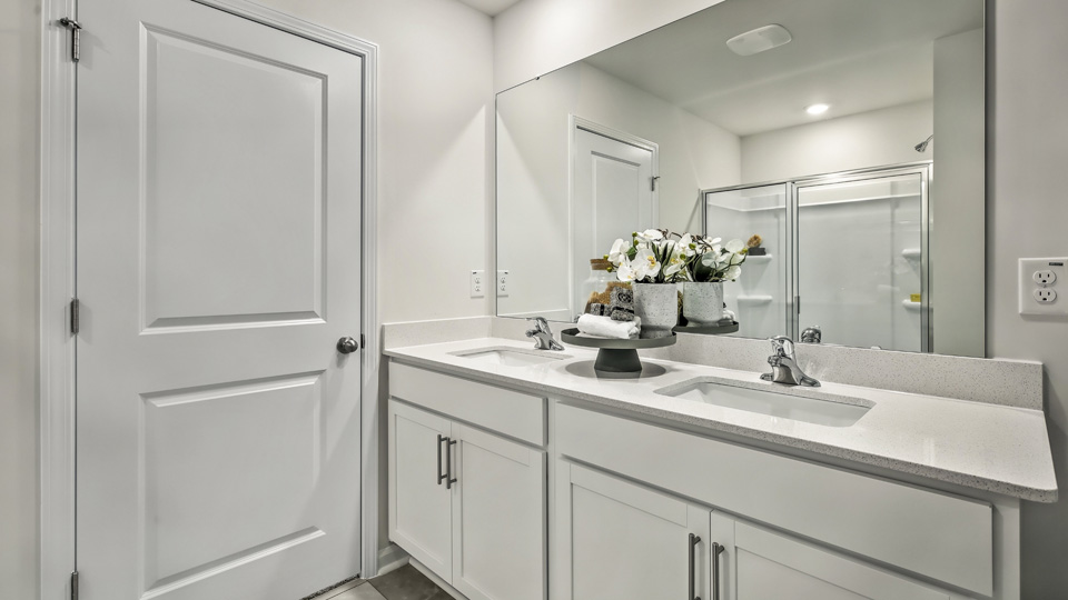 bathroom with quartz countertops and dual vanity