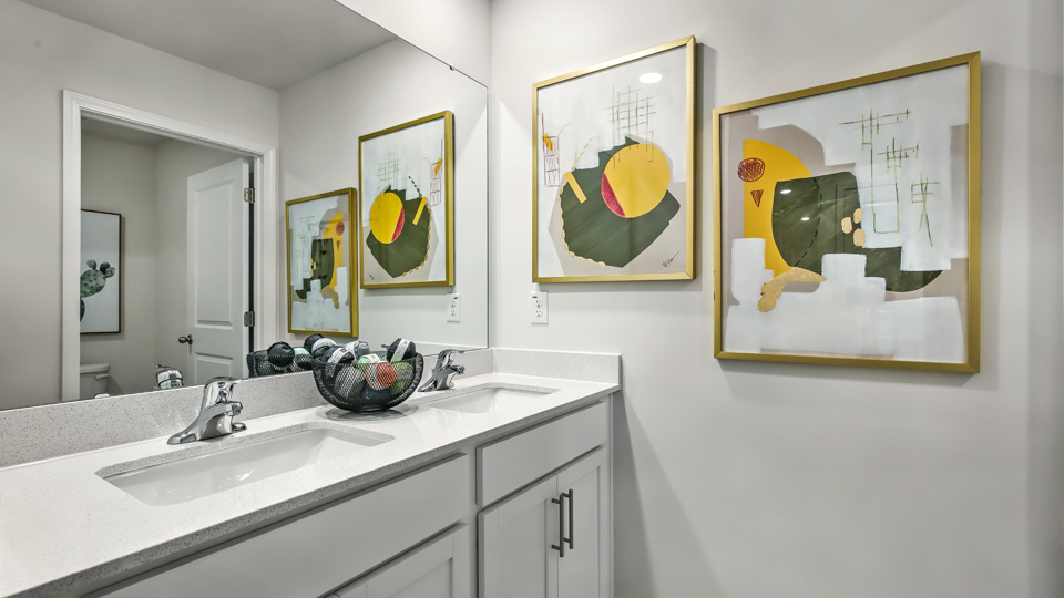 bathroom with quartz countertops and dual vanity