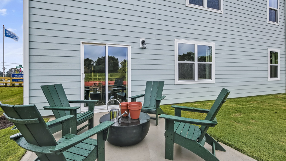 back of home with concrete patio