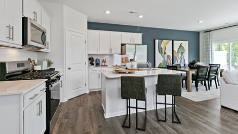 kitchen featuring white cabinetry, large island and stainless steel appliances