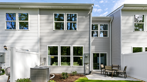 Rear exterior of home featuring a privacy fence