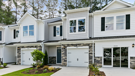 Front exterior of a Denver floorplan home featuring white and grey siding with stone accents