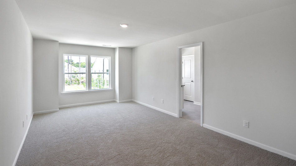 Primary bedroom with carpet flooring